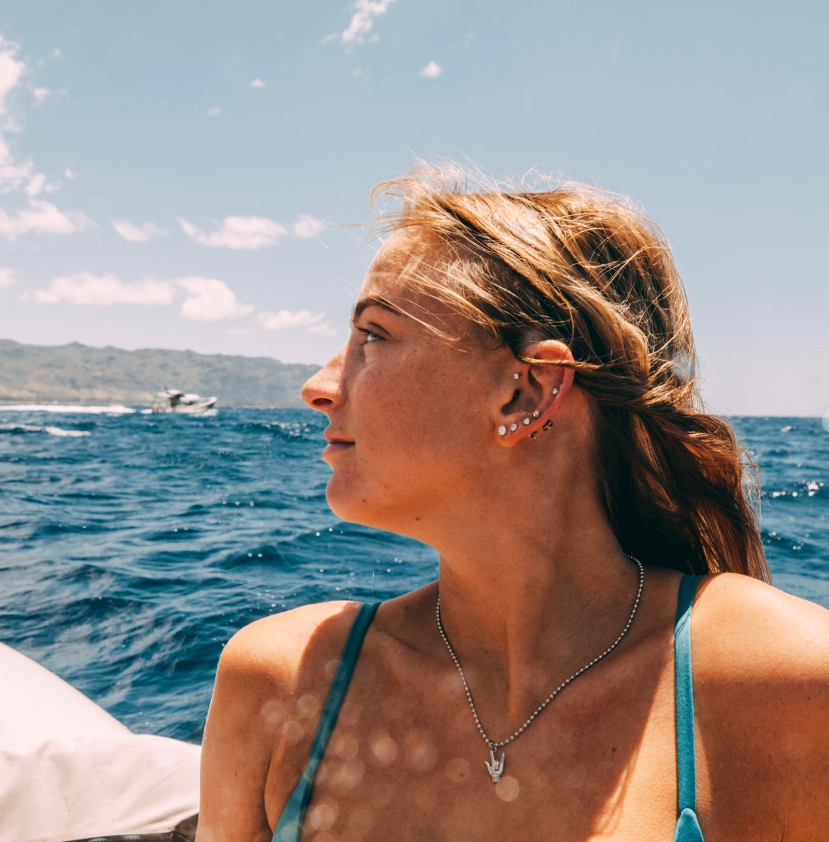 Woman wearing ocean jewelry with ILY Good Vibe Necklace